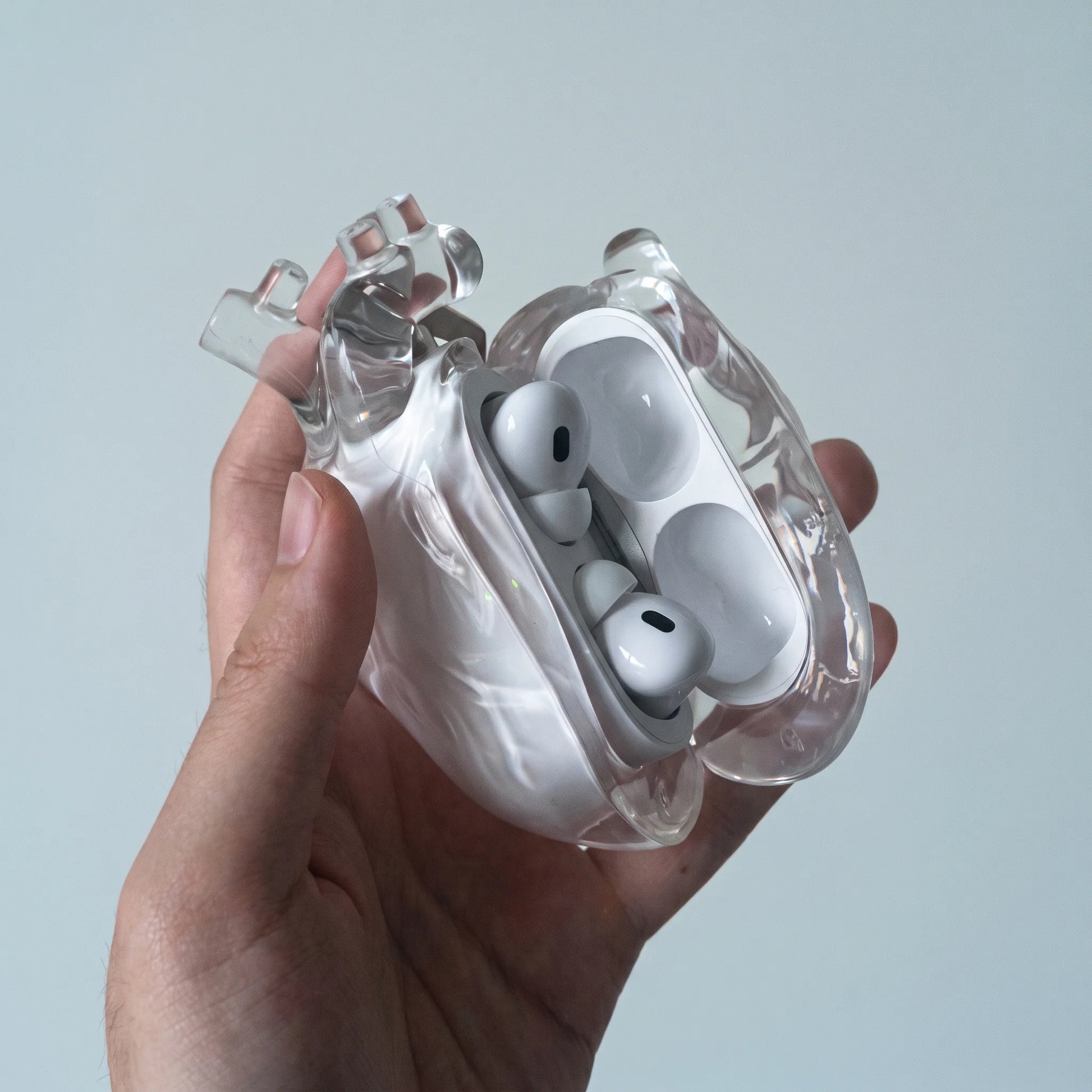 Clear heart AirPods case open, showing the AirPods Pro nestled inside