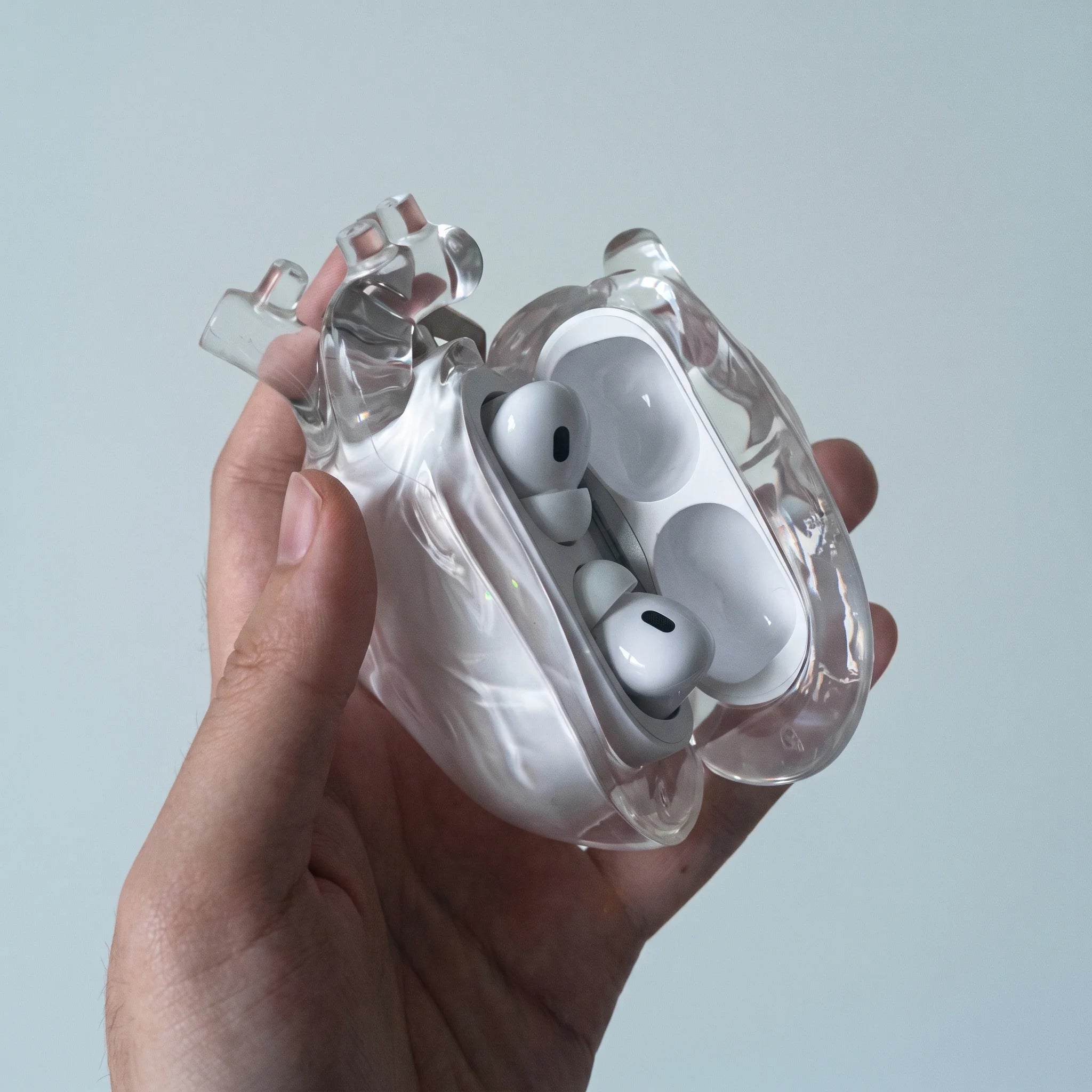 Clear heart AirPods case open, showing the AirPods Pro nestled inside