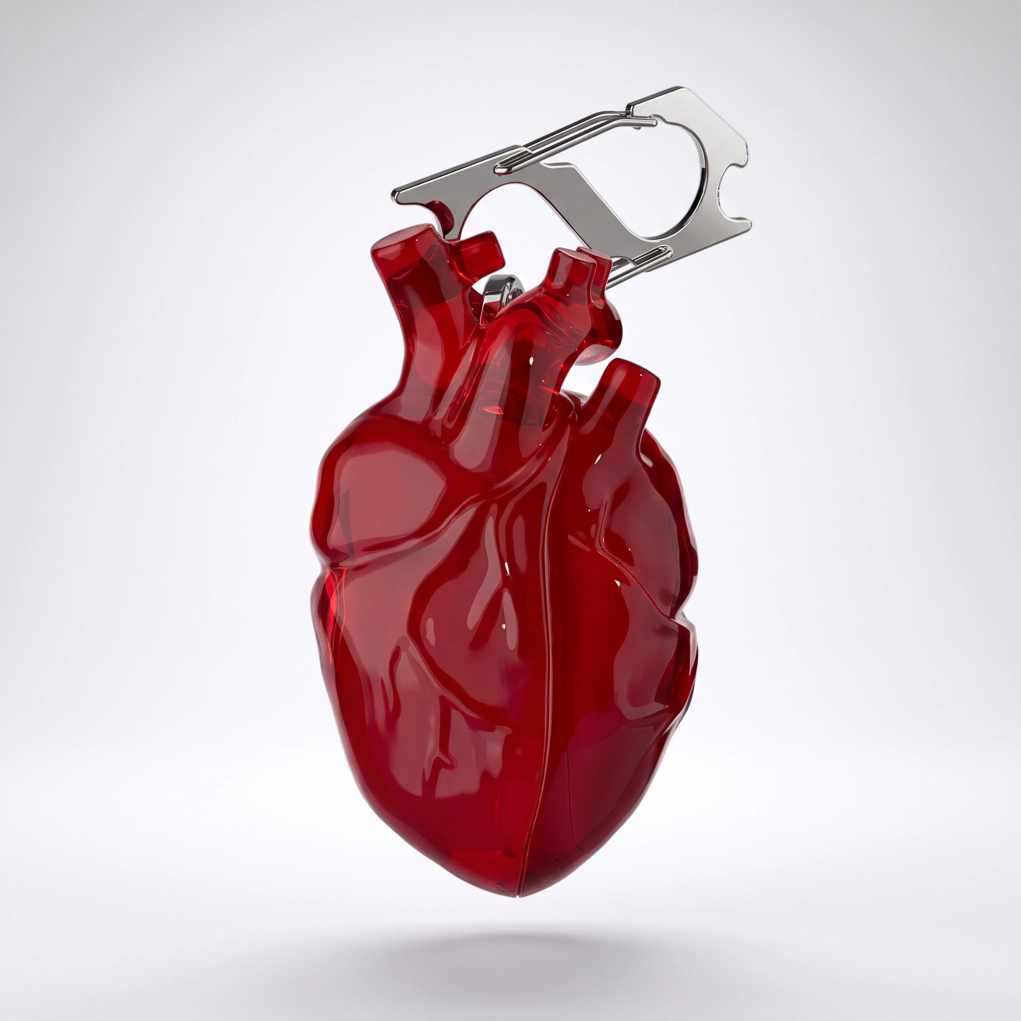 Red anatomical heart AirPods case with its steel carabiner on white
