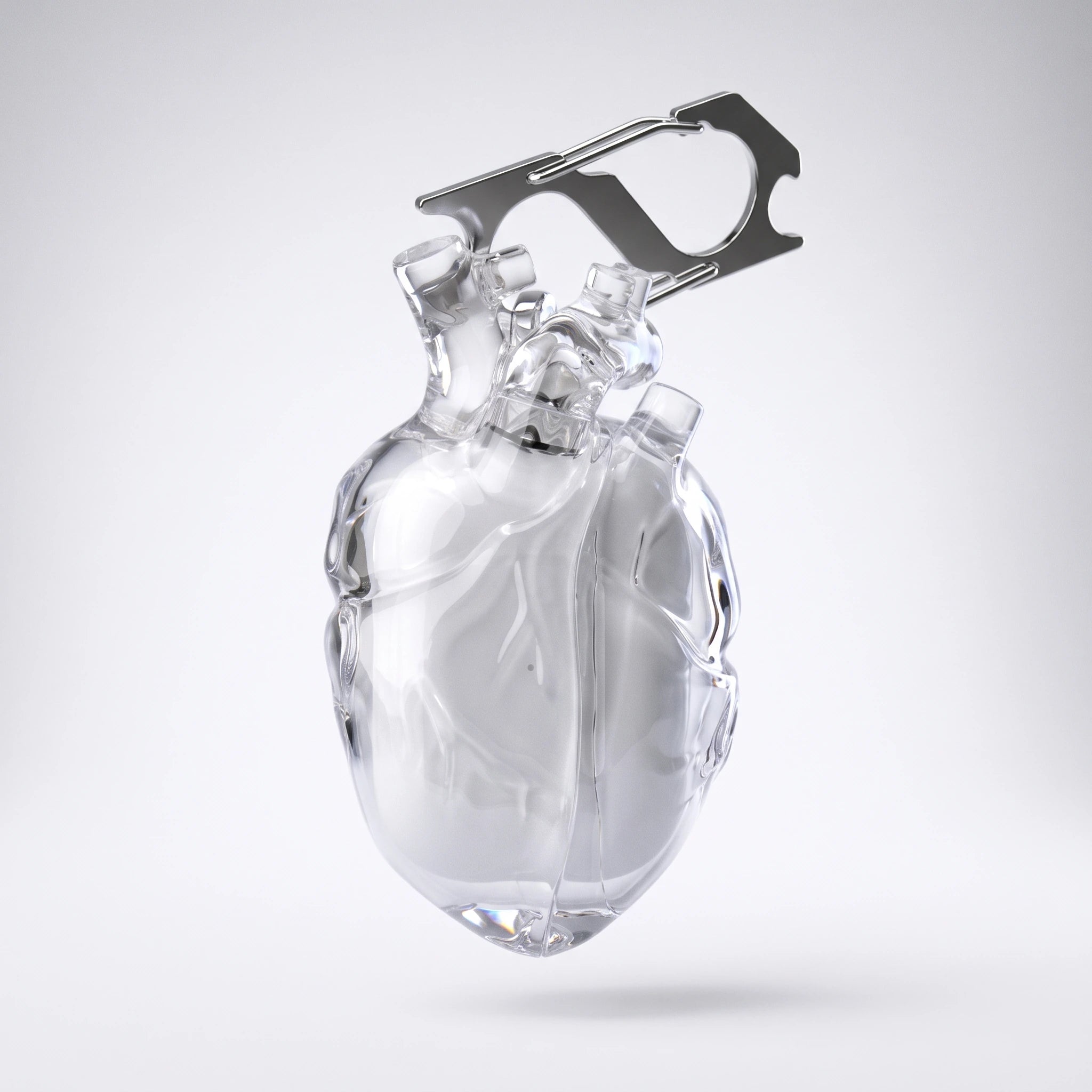 Clear anatomical heart AirPods case with its steel carabiner on white